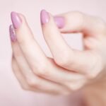 person s hand with pink manicure